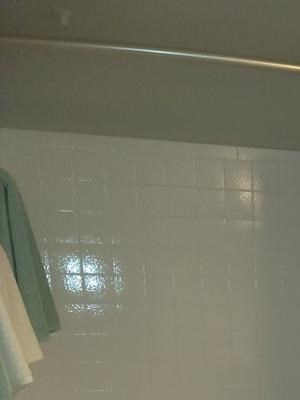 Modern, renovated bathroom with dark counters and gray cabinets at Park 9690 in Dallas, TX